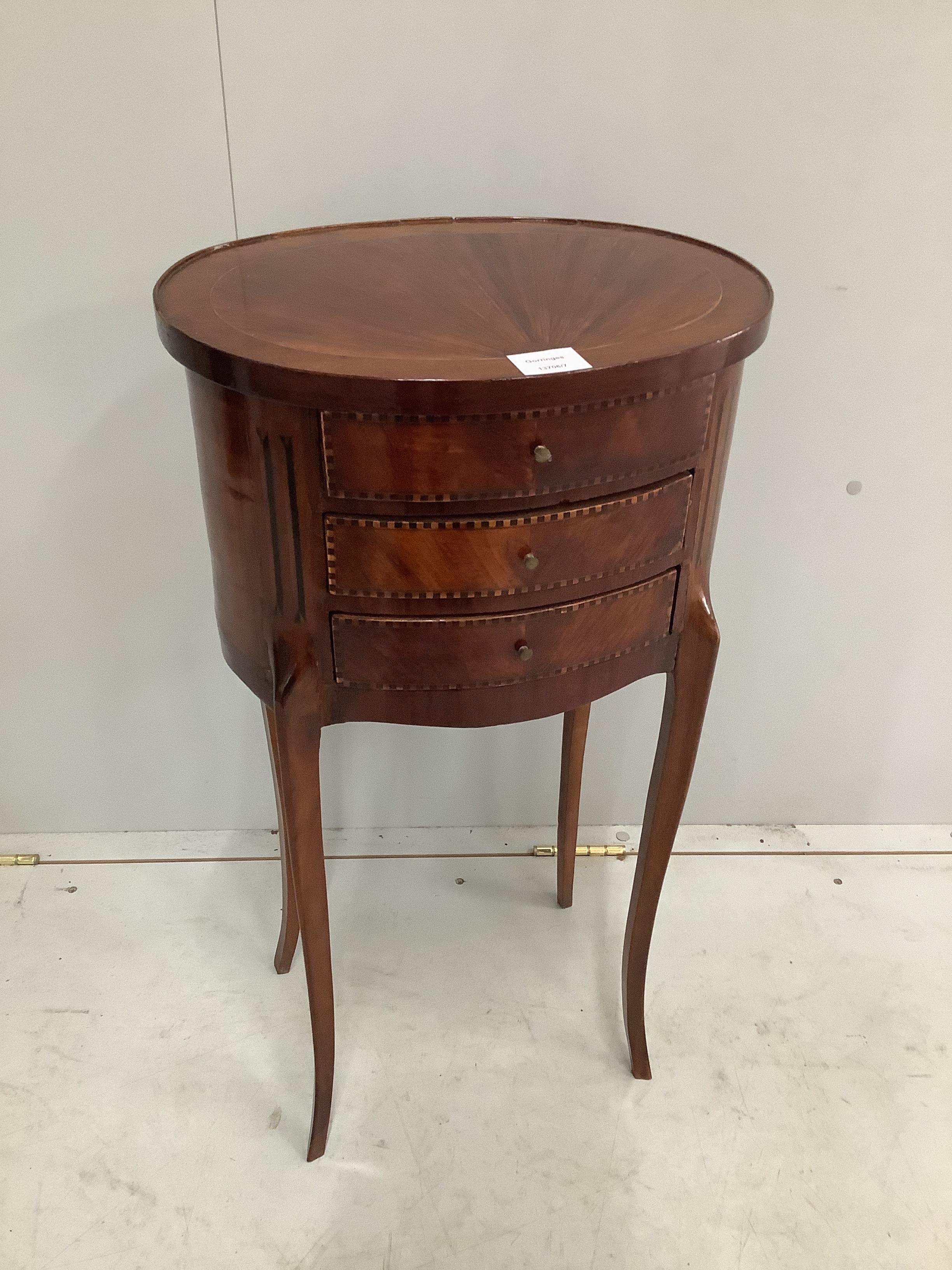 A French oval kingwood three drawer occasional table, width 39cm, depth 30cm, height 75cm